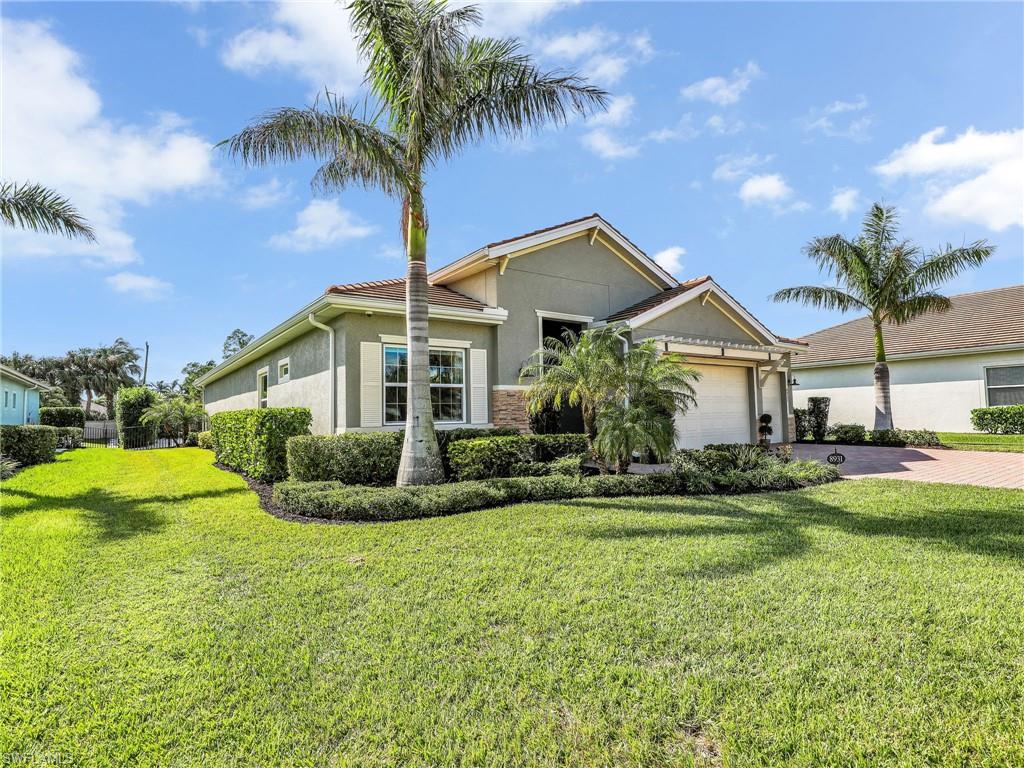 View of front of property with a garage and a front yard