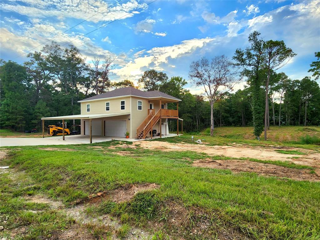 a view of a house with backyard and sitting area