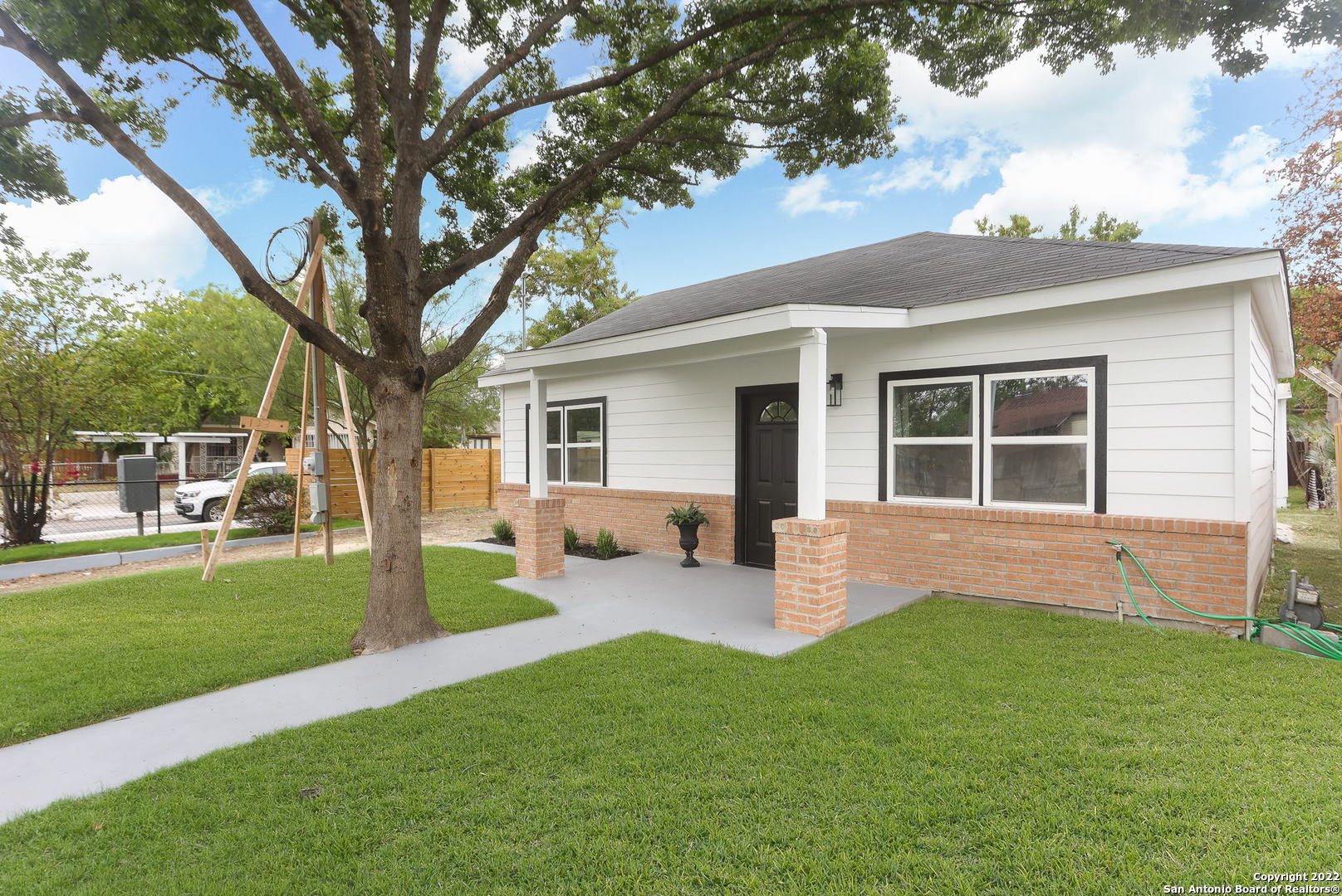 a front view of house with a garden and patio