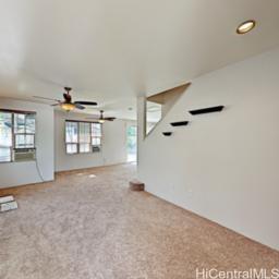 an empty room with windows and cabinet