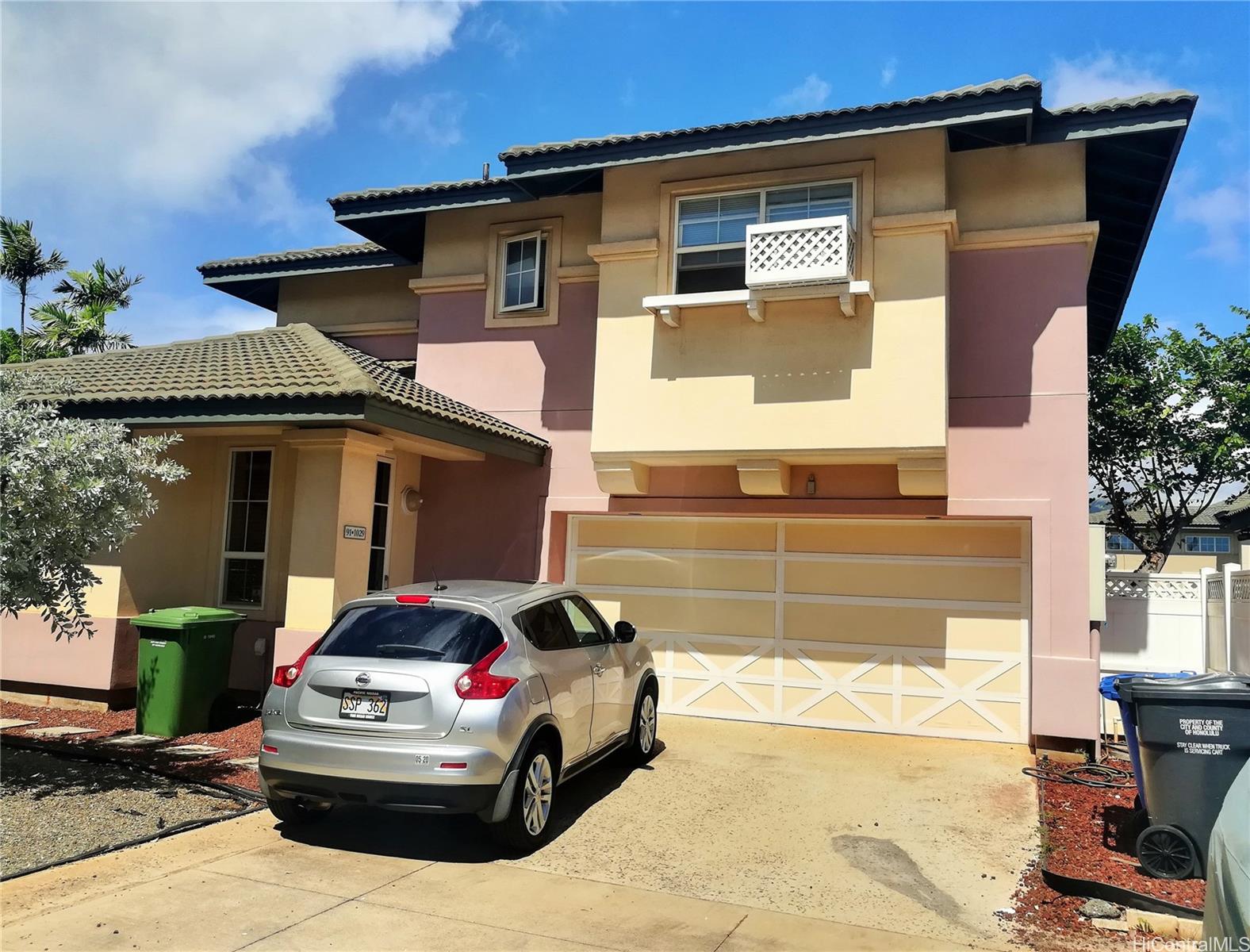 Two story home with fenced in landscaped yard in Iwalani @ Kapolei. 2 car garage with space to park 2 cars in driveway