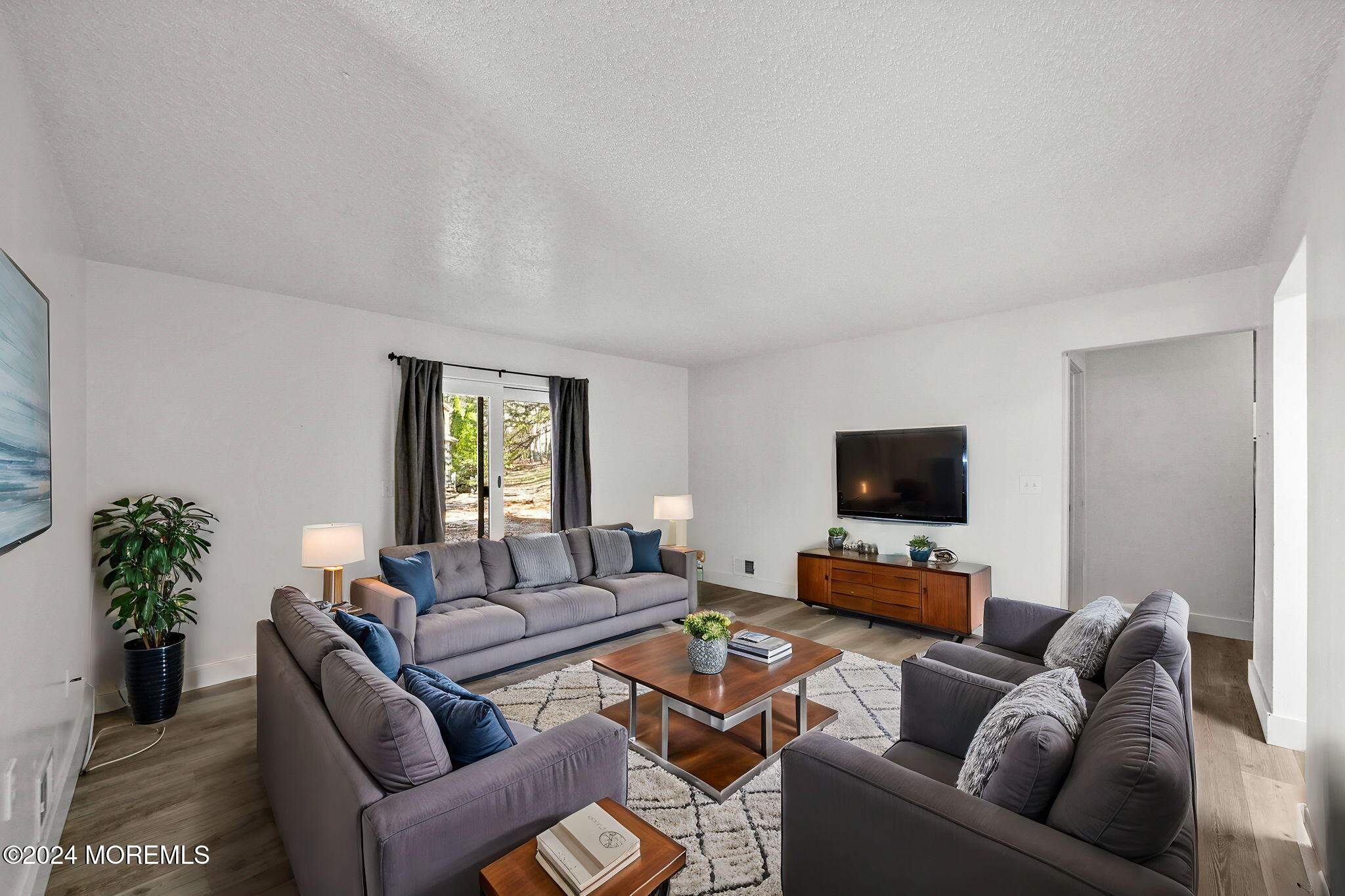 a living room with furniture and a flat screen tv