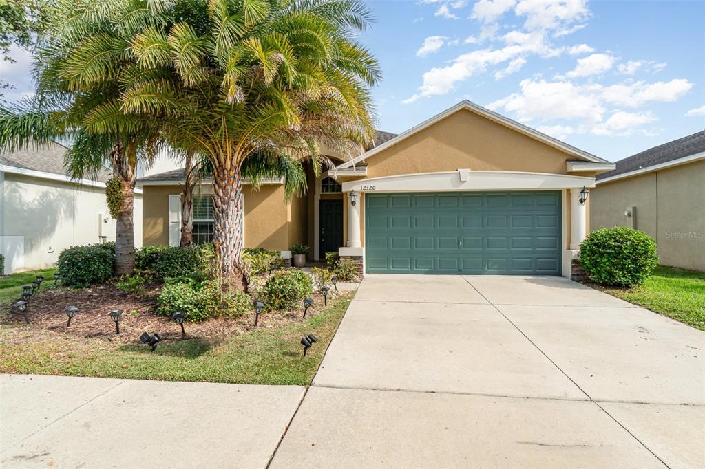 a front view of a house with a yard and garage