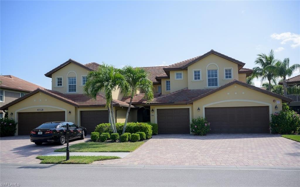 a front view of a house with a garden and yard