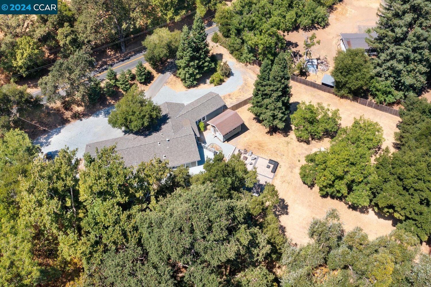 an aerial view of a house with a yard and lake view