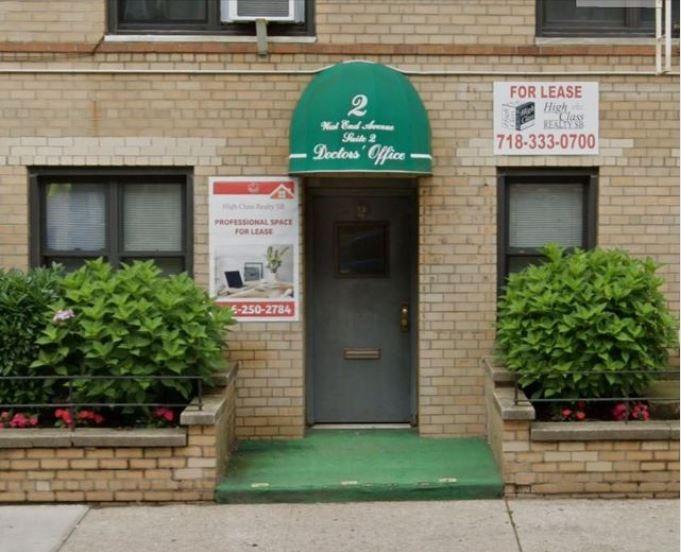 a front view of a building with potted plants