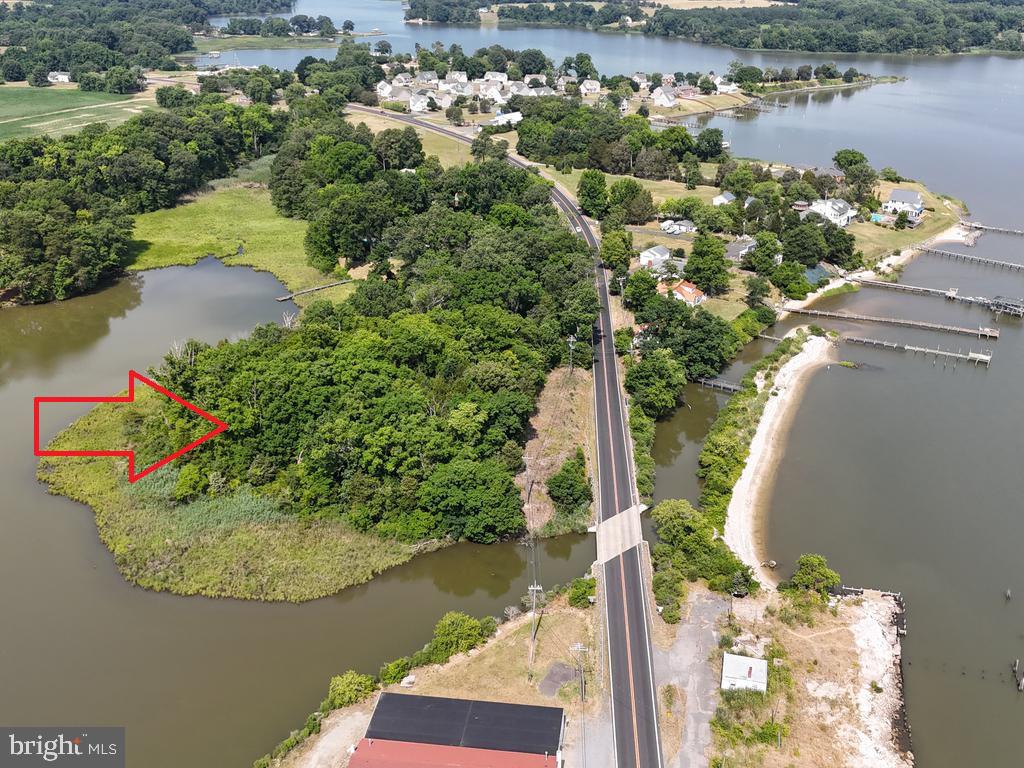 an aerial view of a house with a yard and lake view