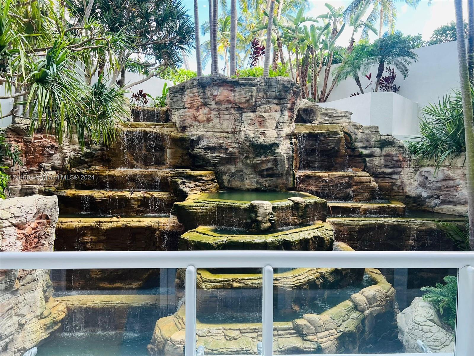 a view of swimming pool with lawn chairs plants