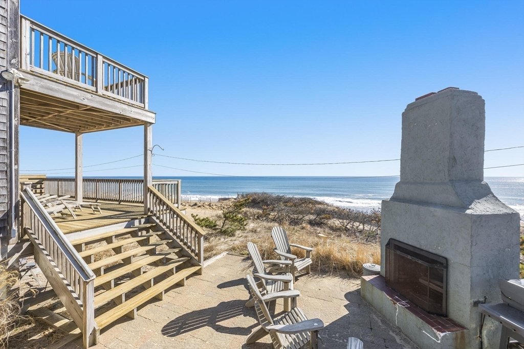 a view of balcony with two chairs and a rug