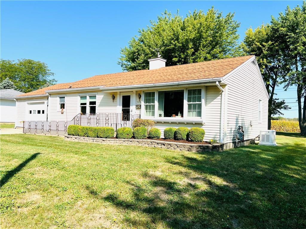 a view of a house with backyard and sitting area