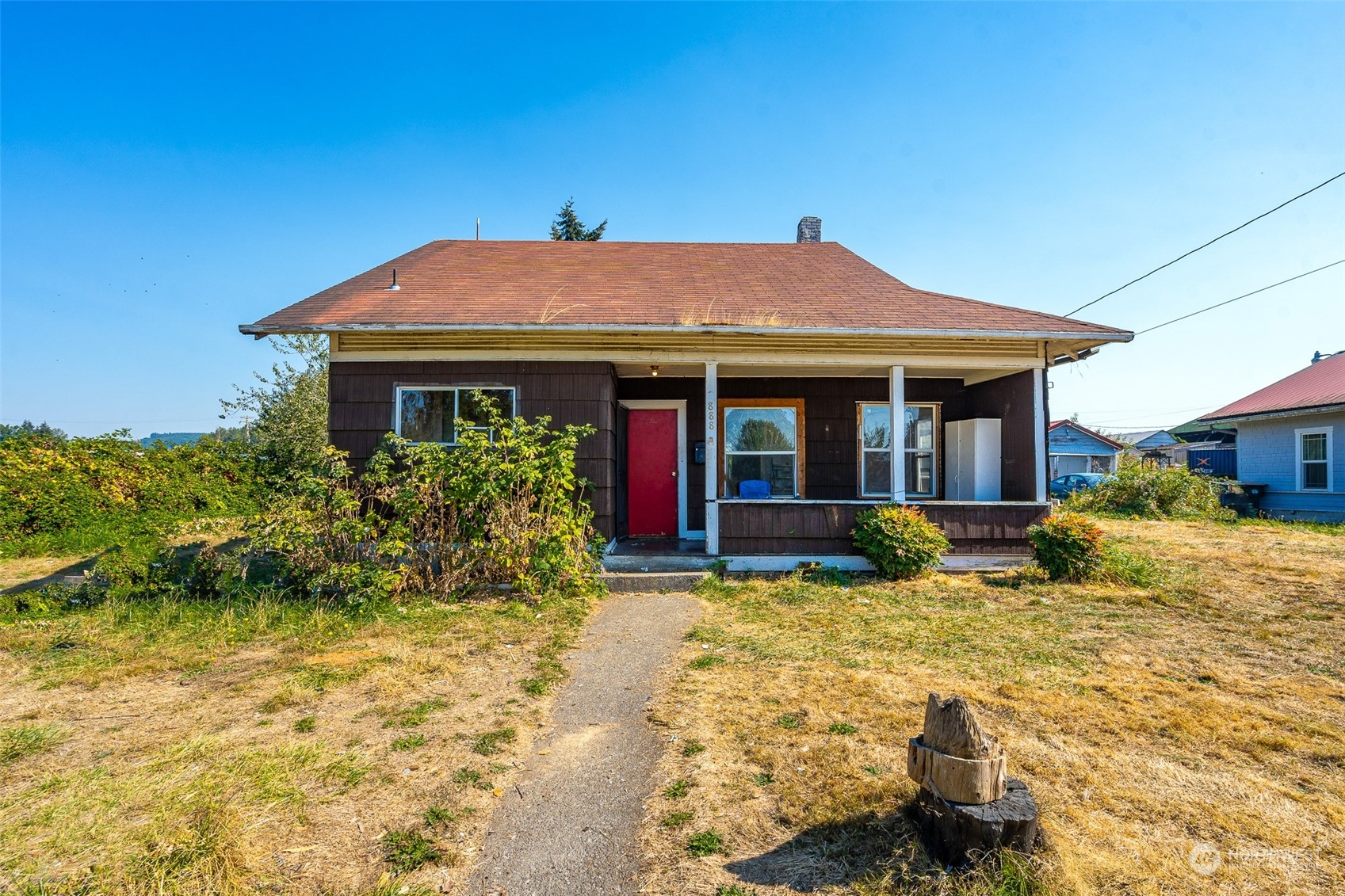 a view of a house with a small yard and sitting area