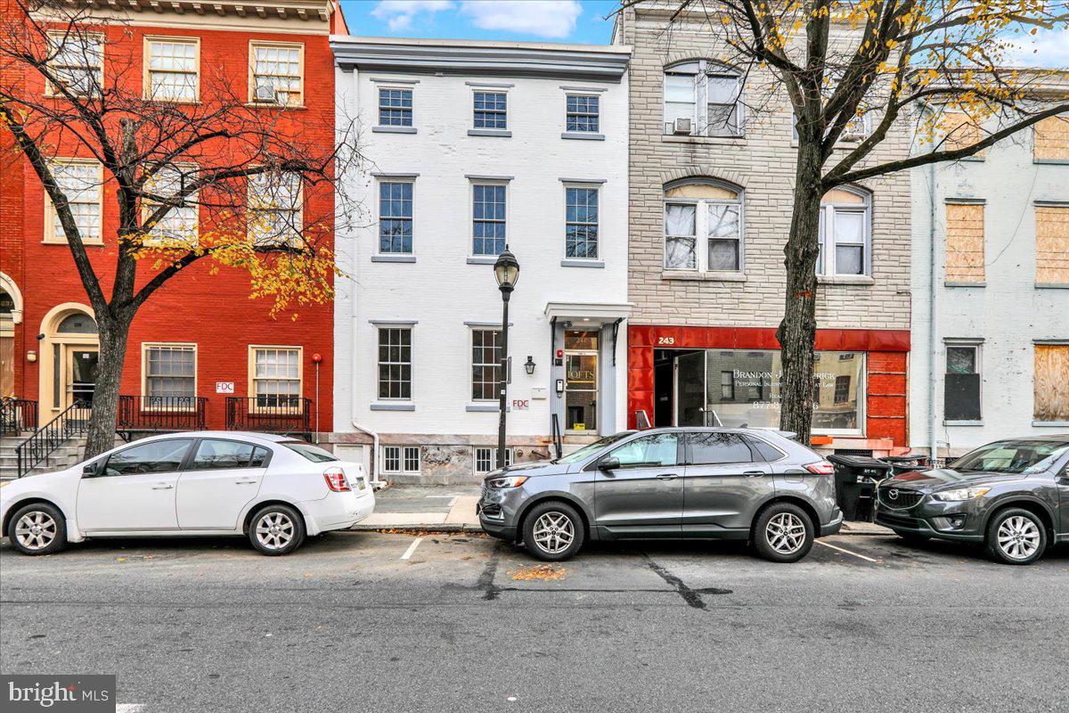 a view of a cars park in front of a building