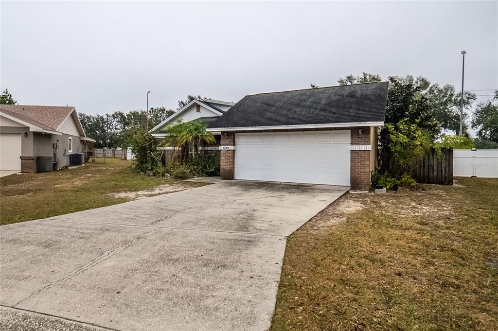 a view of a house with a yard and plants