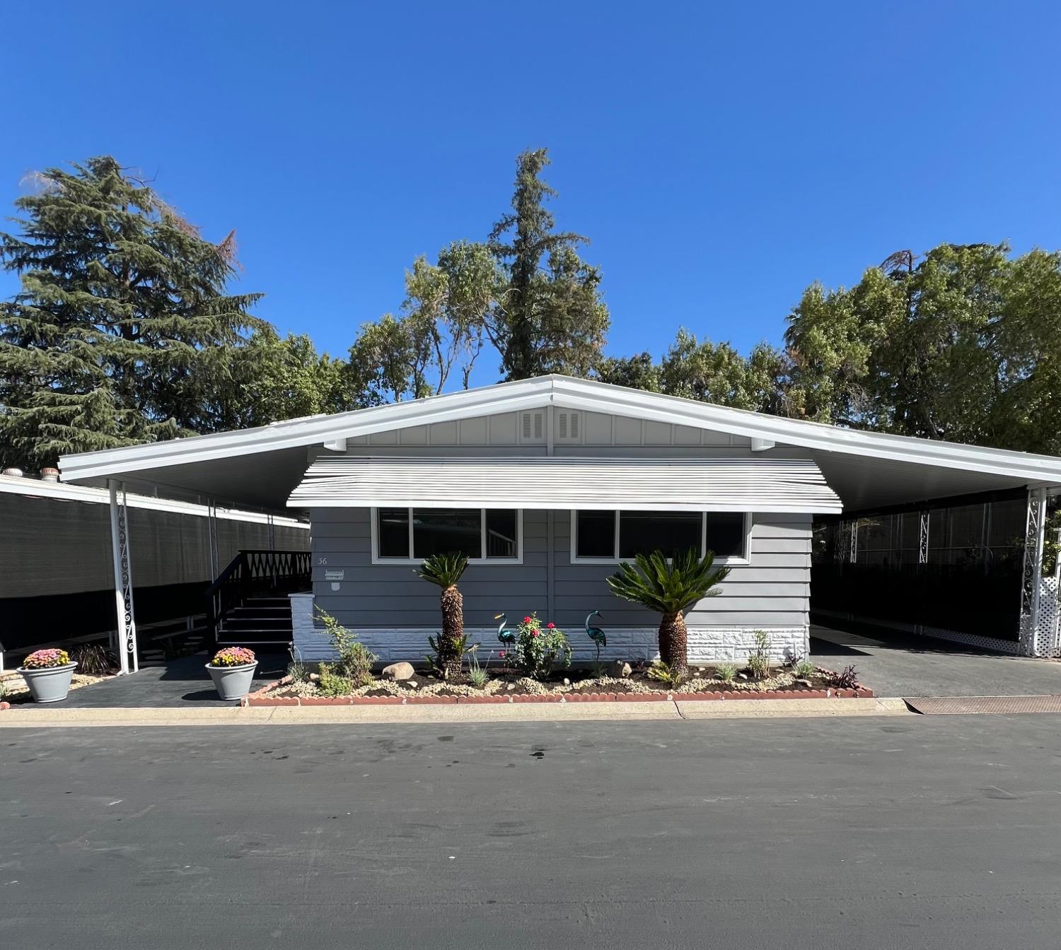 a front view of a house with yard and garage