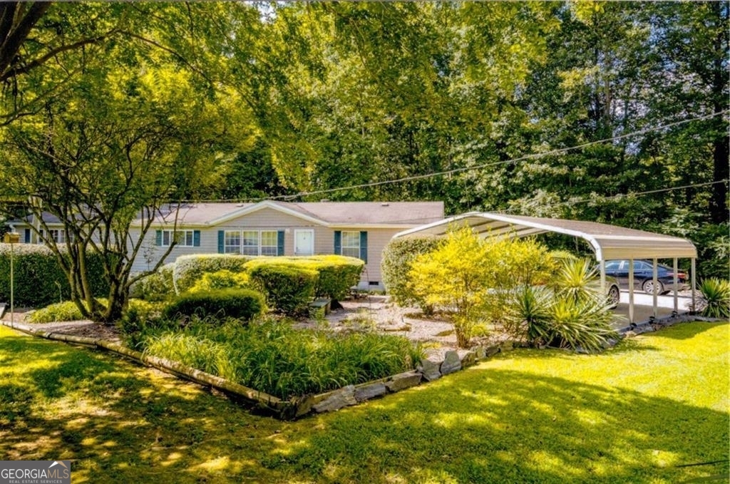 a front view of house with yard and green space