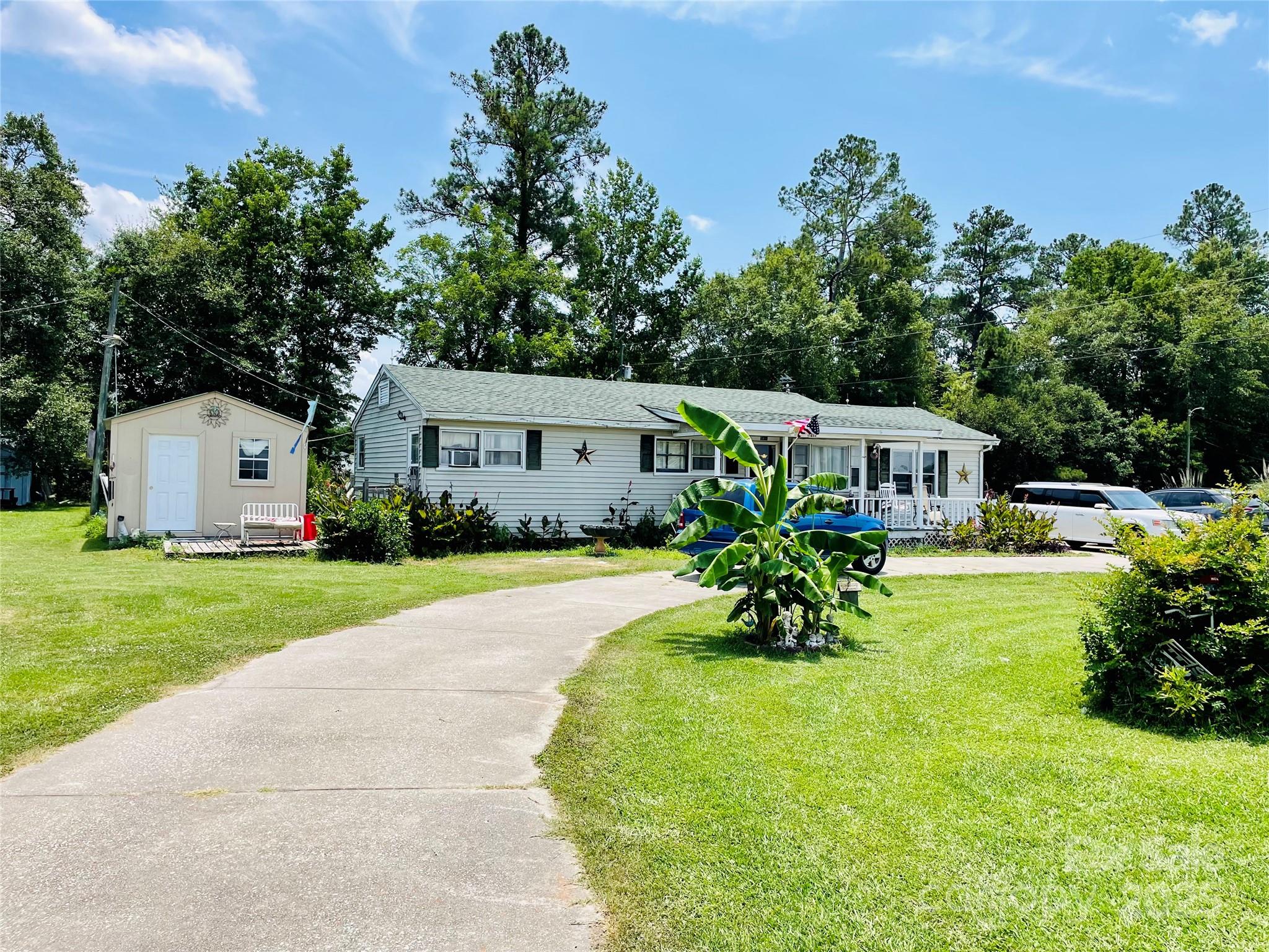 a front view of house with yard and outdoor seating