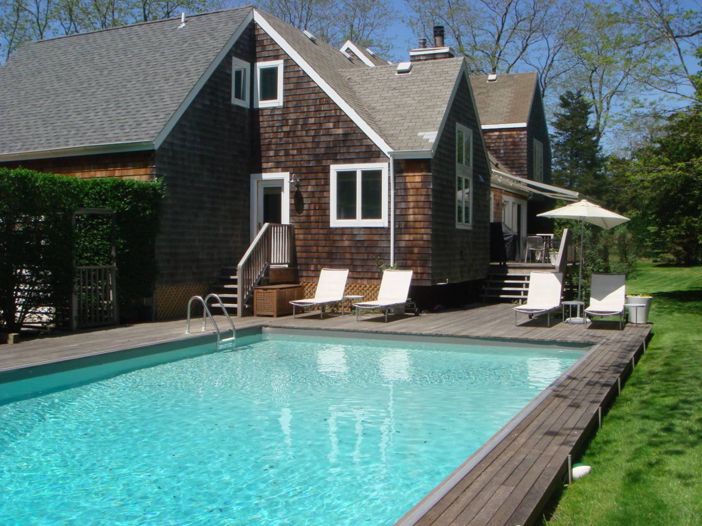 a view of a house with backyard porch and sitting area