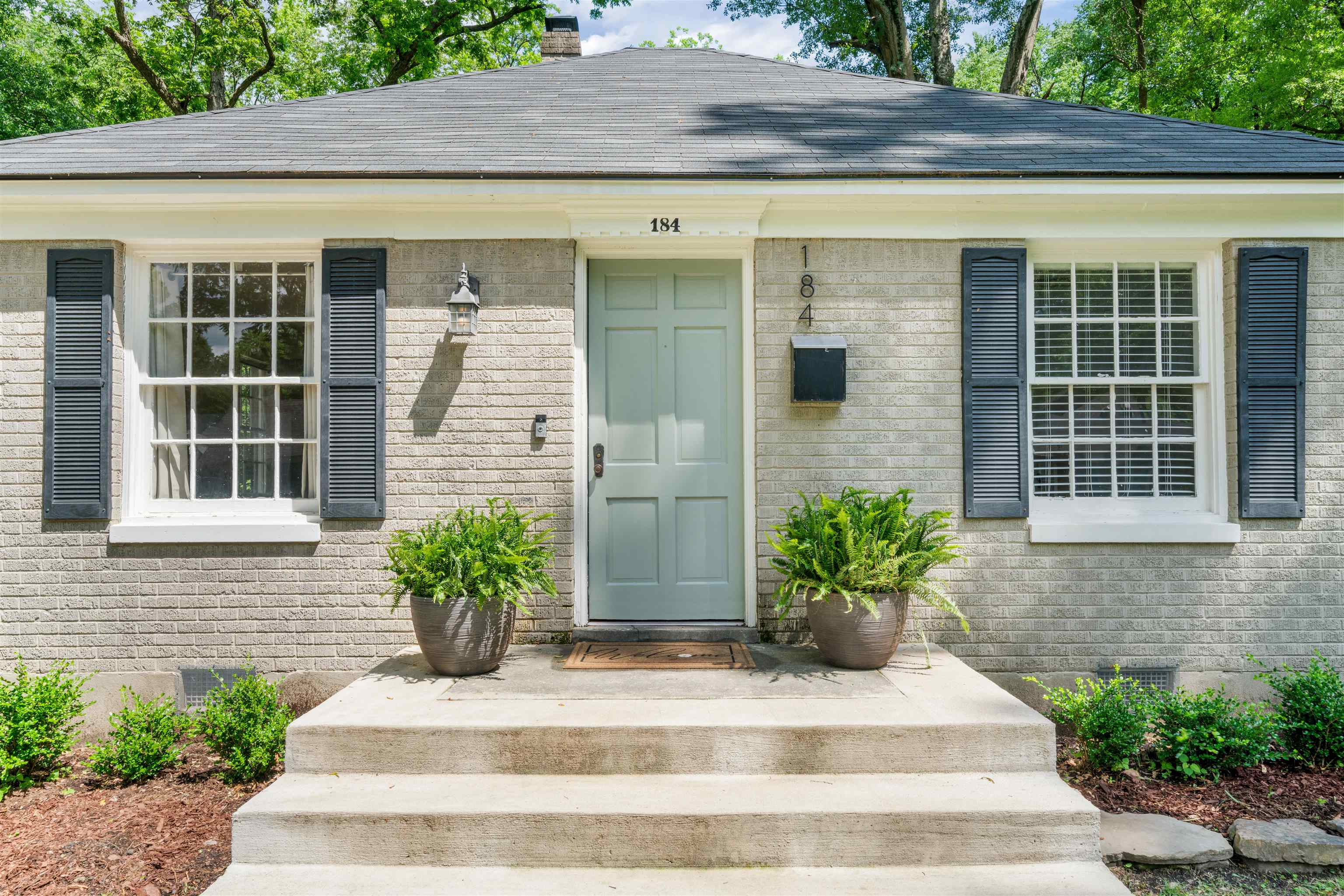 a front view of a house with a garden