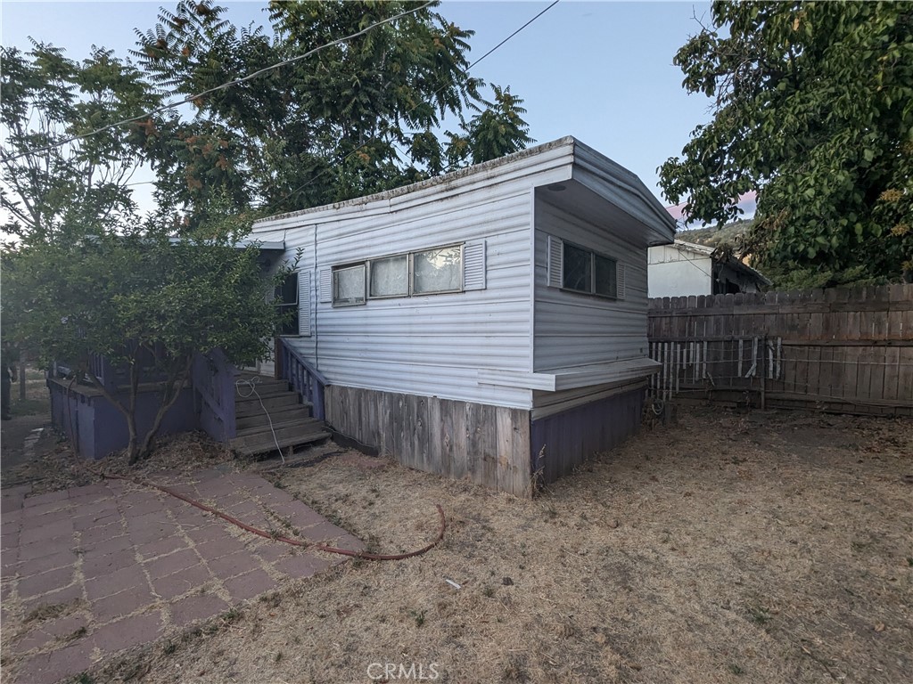 a view of a wooden house with a yard