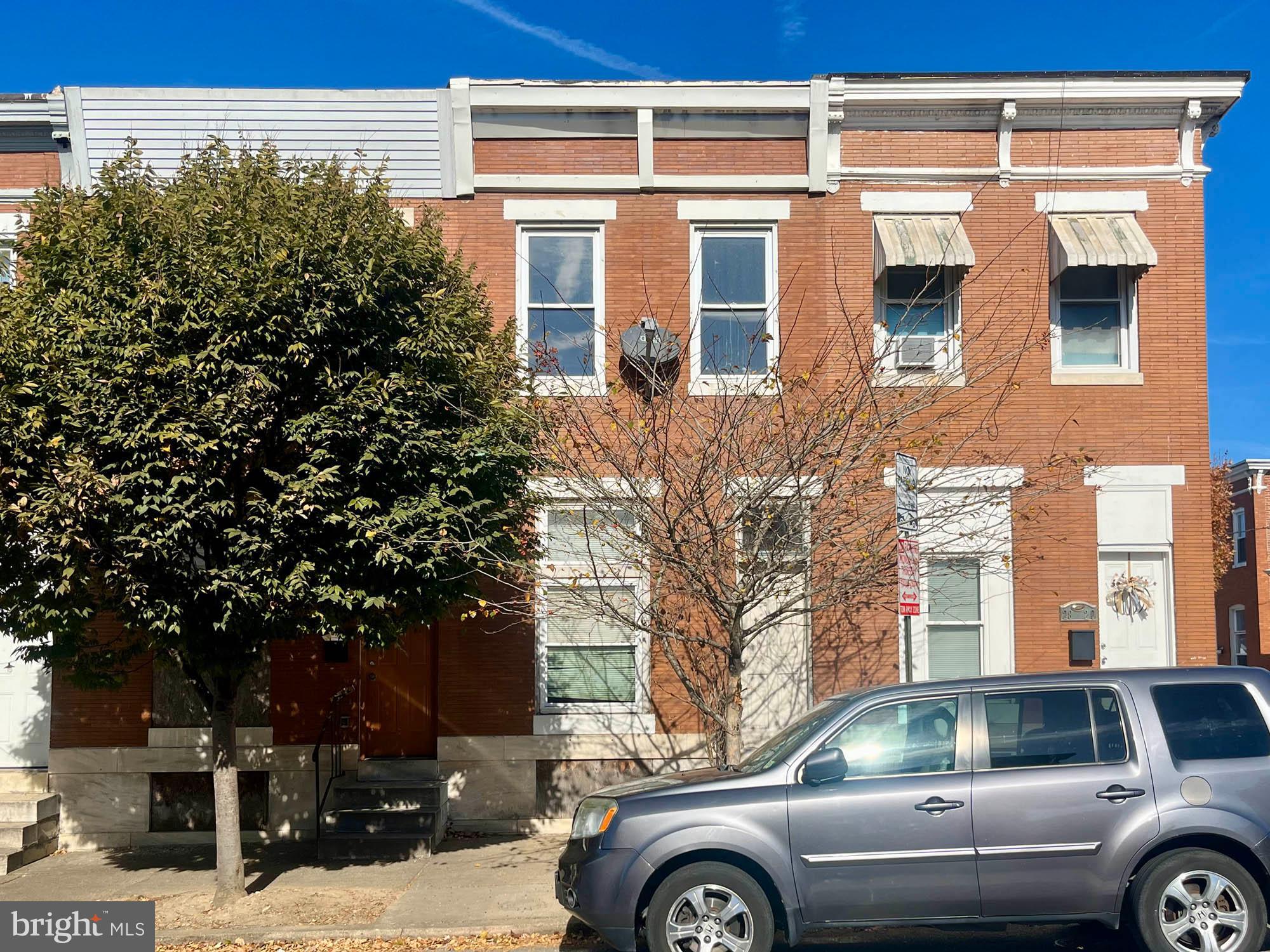 a front view of a building with parking space