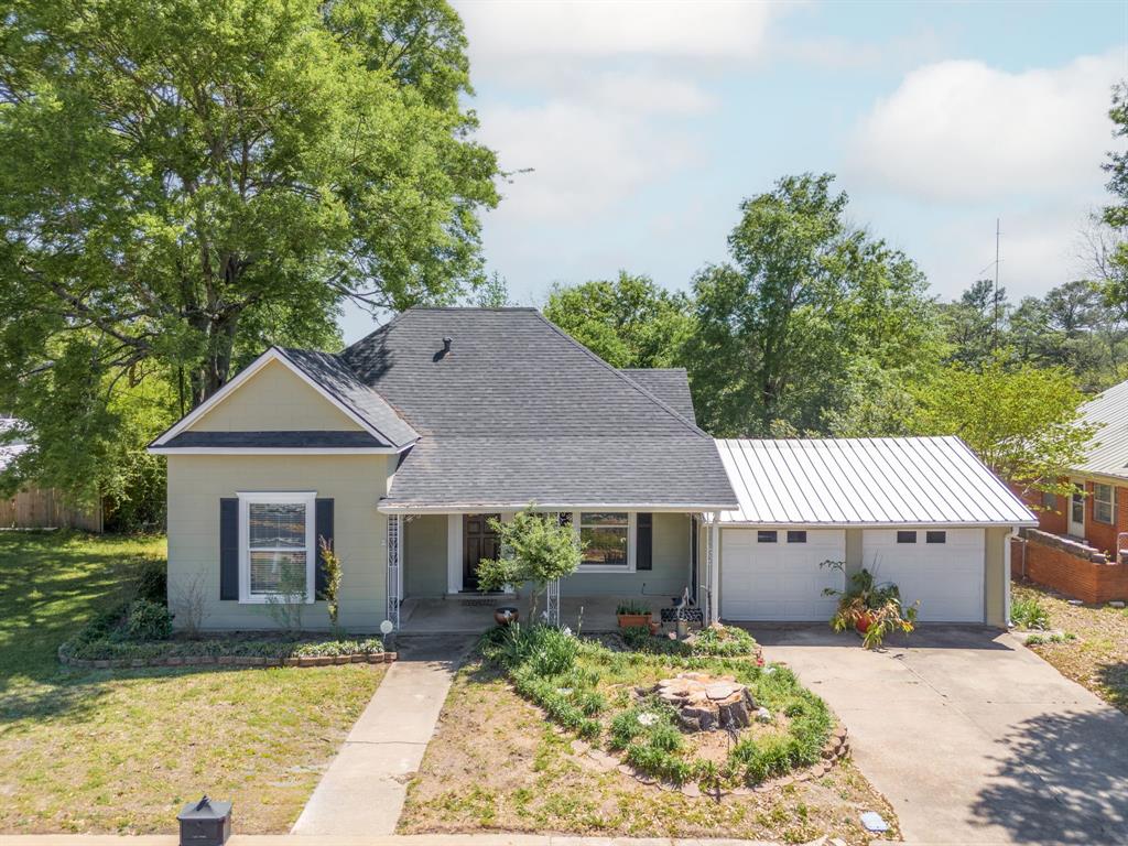 a front view of a house with a yard outdoor seating and garage