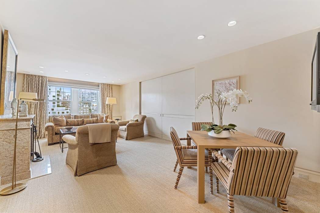 a dining room with furniture a rug and a chandelier