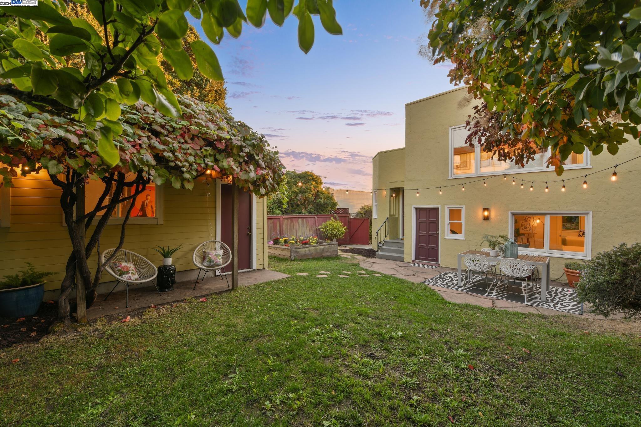 a view of a backyard with table and chairs and a fire pit