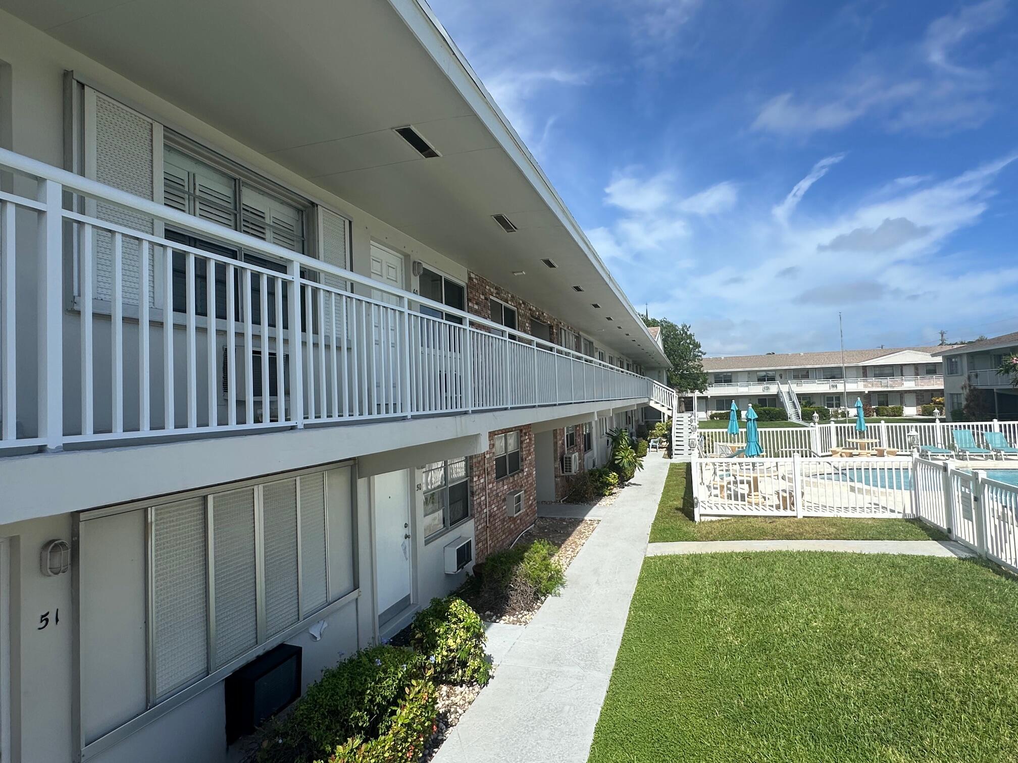 a view of a swimming pool with an outdoor seating