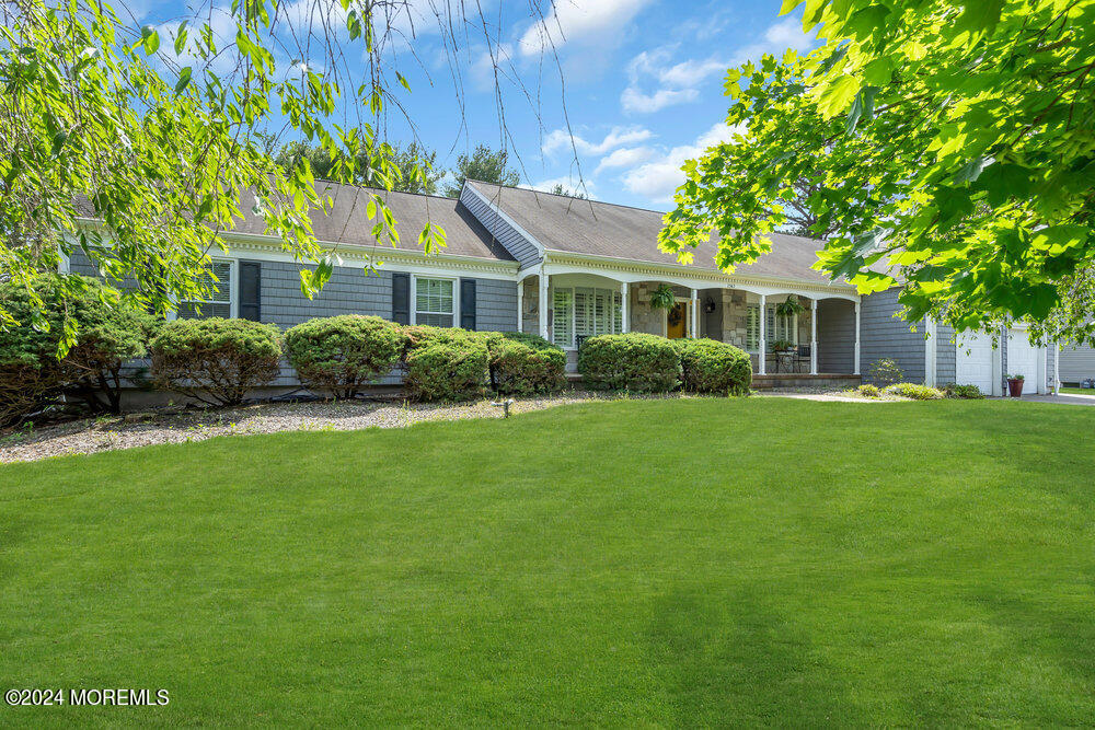 a front view of house with yard and green space