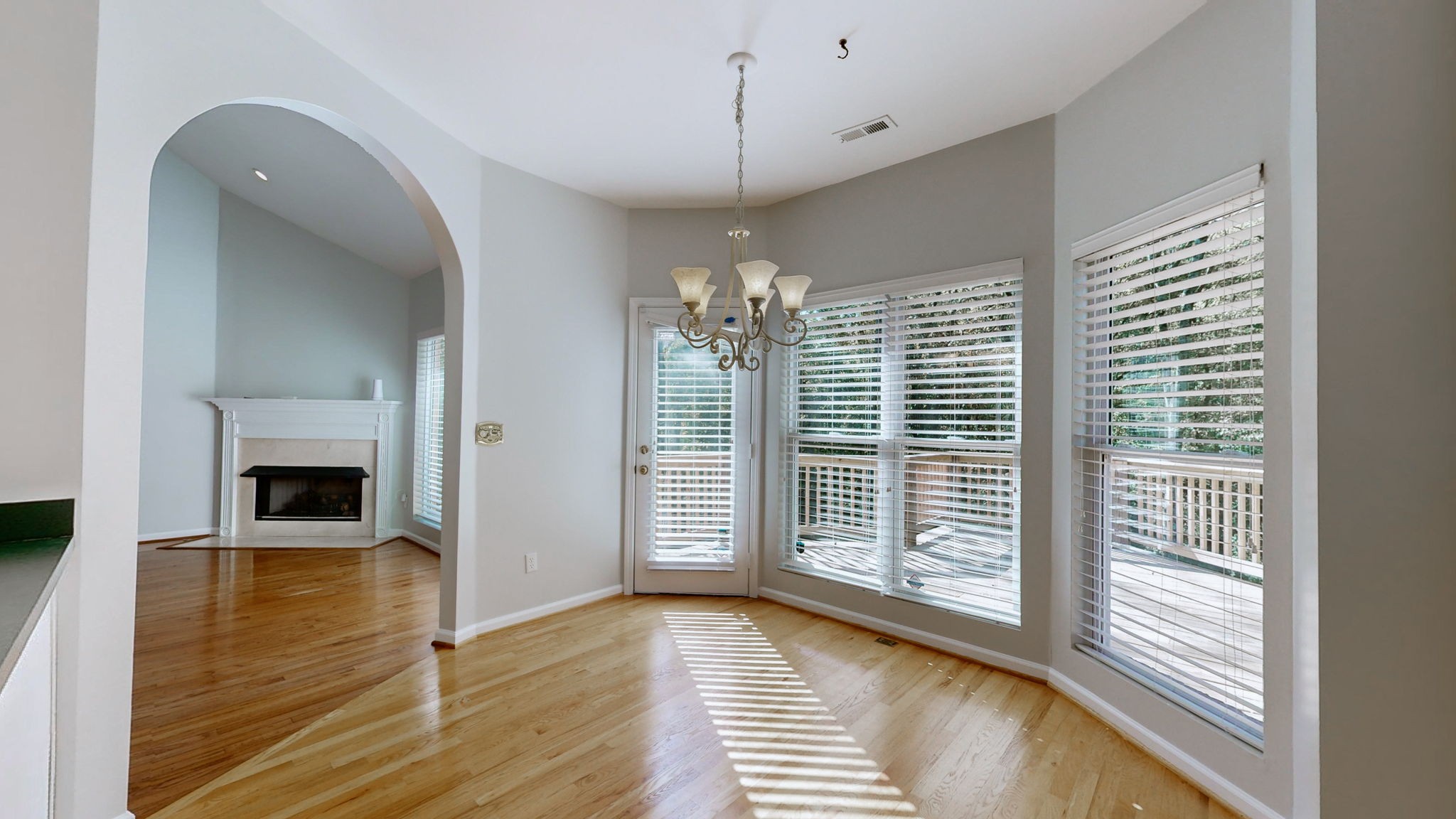 a view of a livingroom with wooden floor and a large window