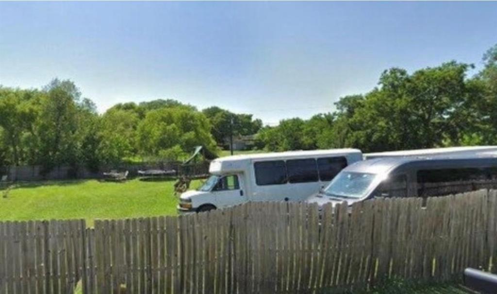 a view of a white house with a yard and sitting area