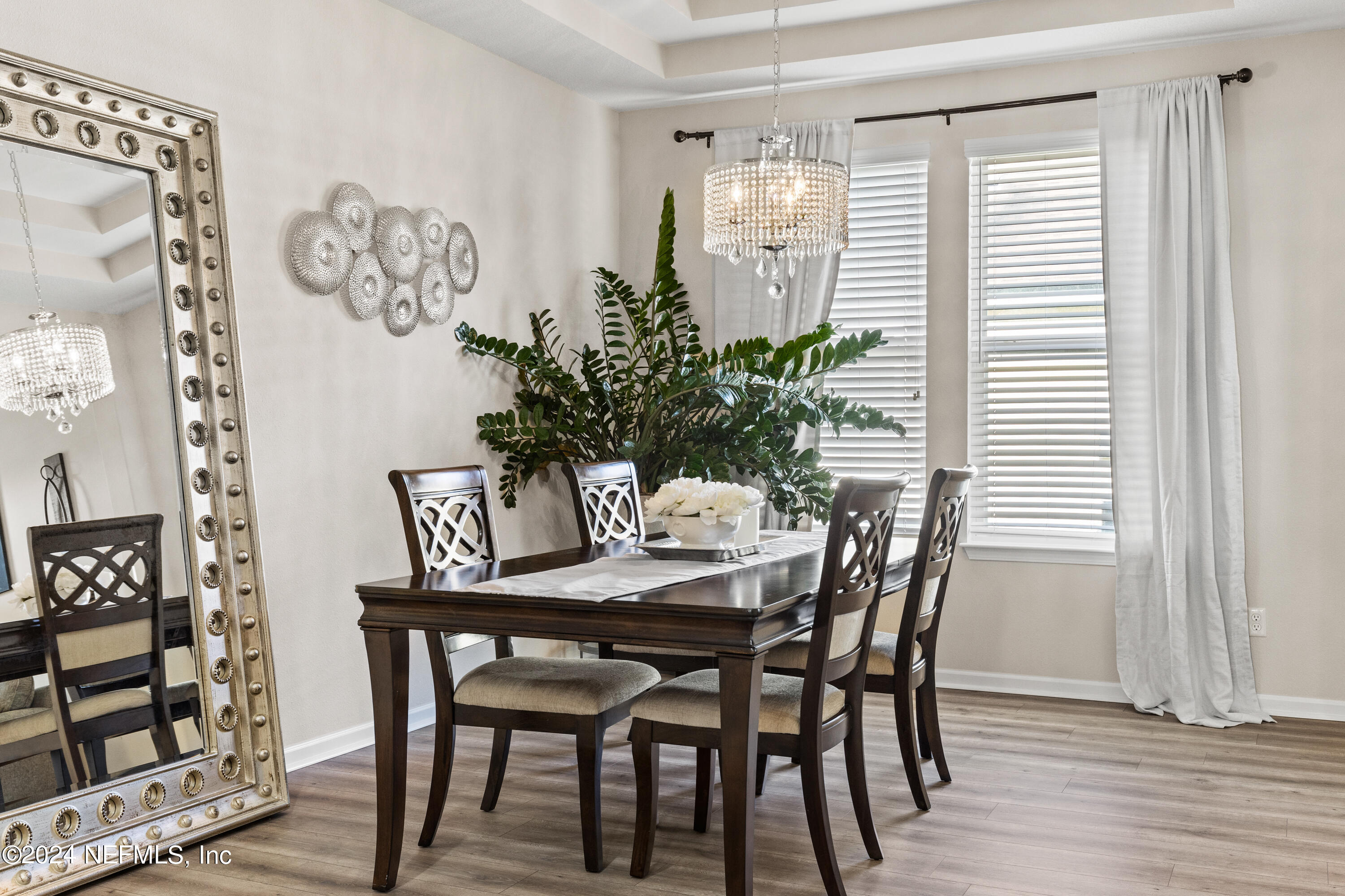 a dining room with furniture and wooden floor