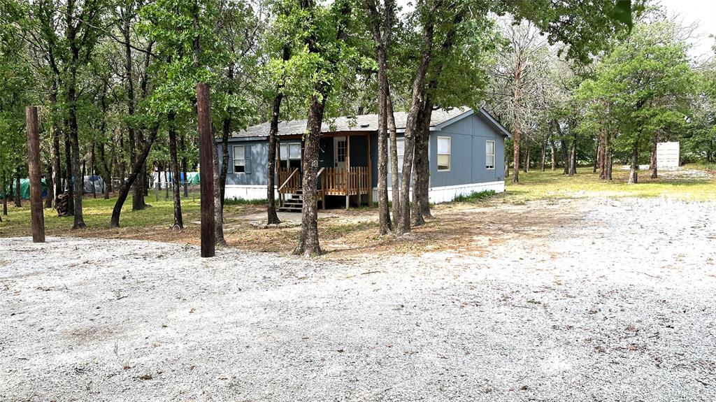 a view of a house with backyard and tree