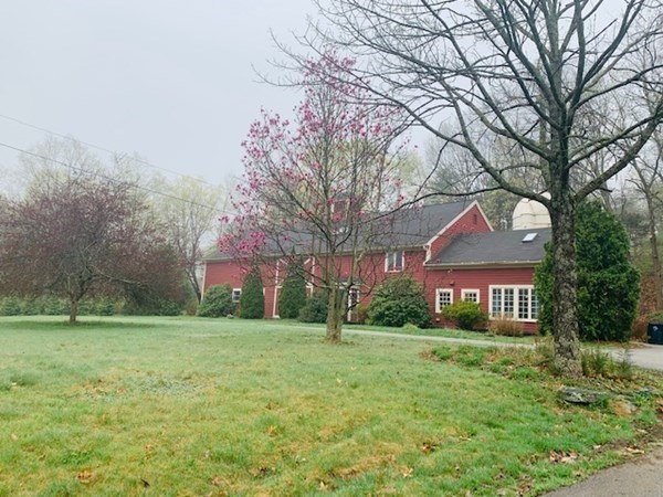 a brick house with trees in front of it