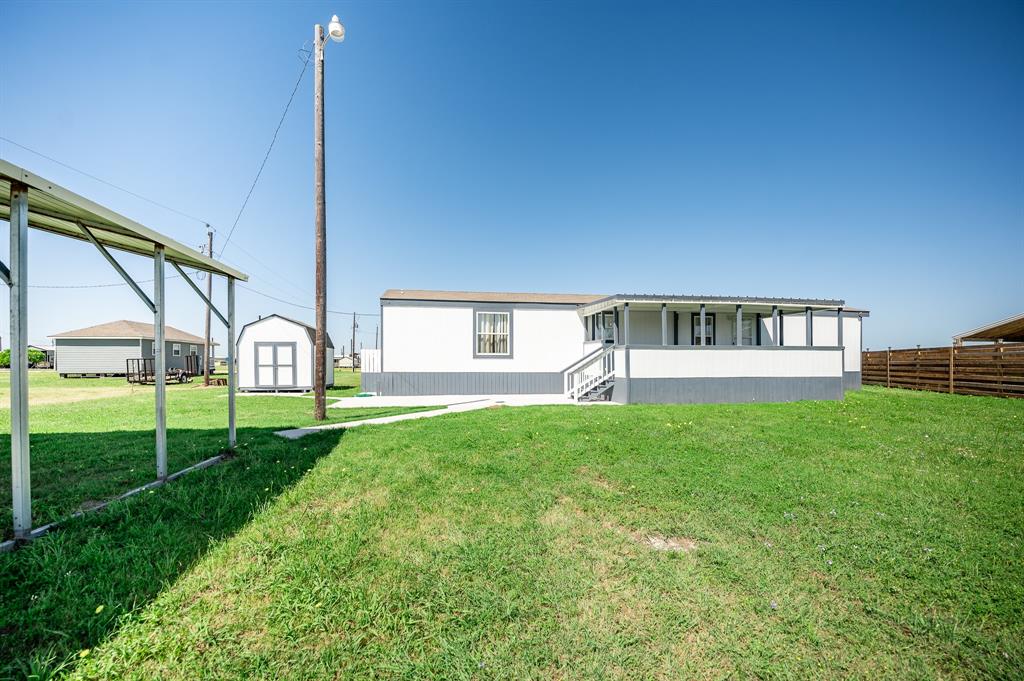 a view of a house with backyard and a tree