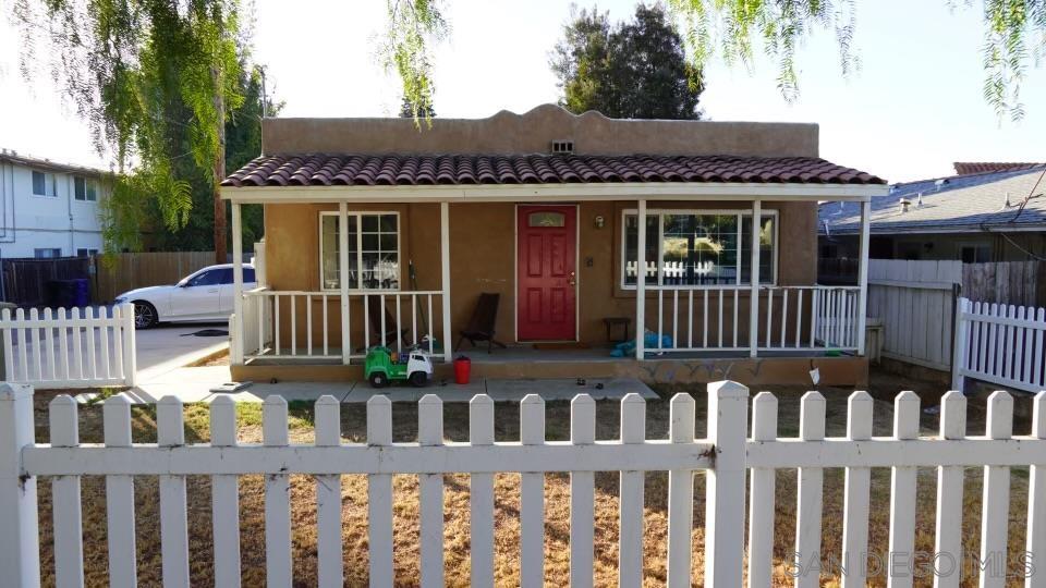 a view of a house with wooden deck and furniture