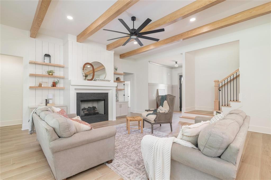 a living room with furniture a clock and a fireplace