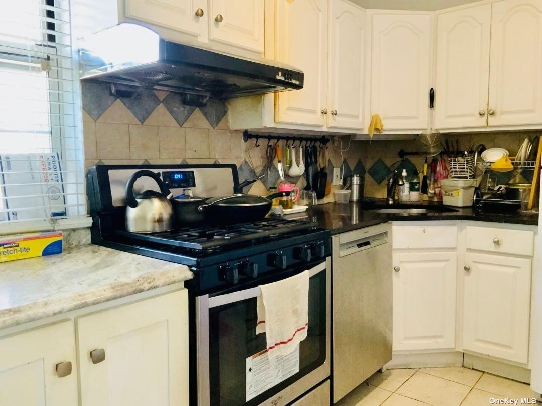 a kitchen with stainless steel appliances granite countertop a stove and cabinets