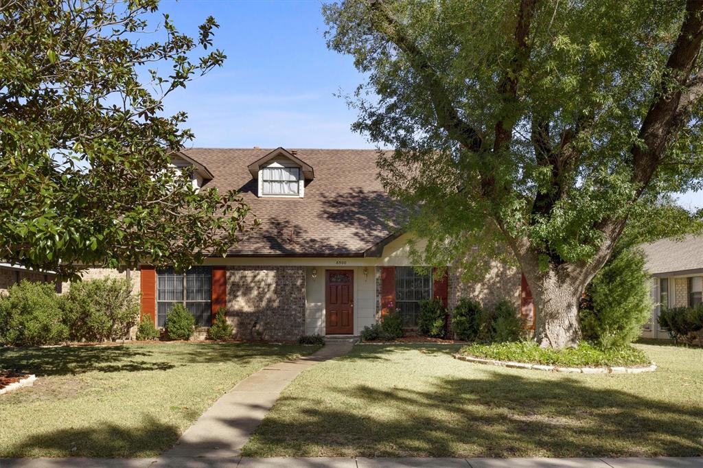 a view of a trees in front of a house