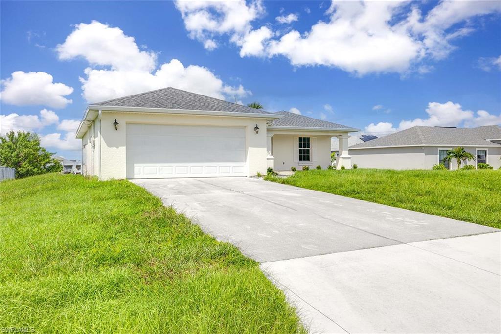 a front view of a house with a yard and garage