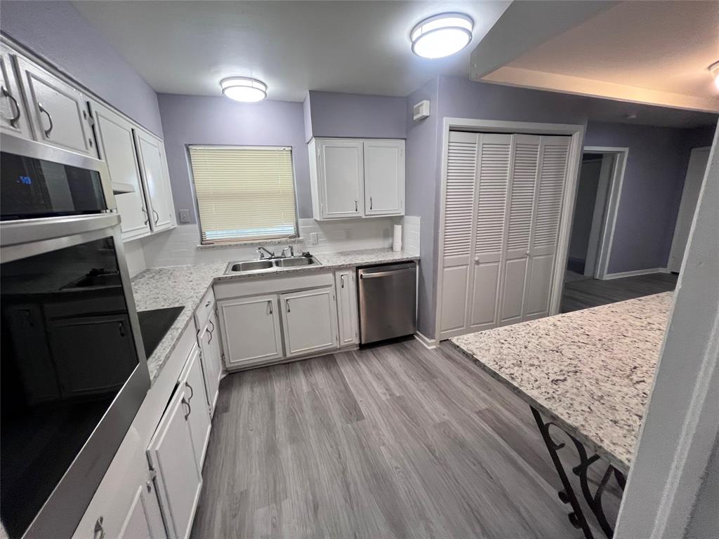 a kitchen with a sink stove and refrigerator