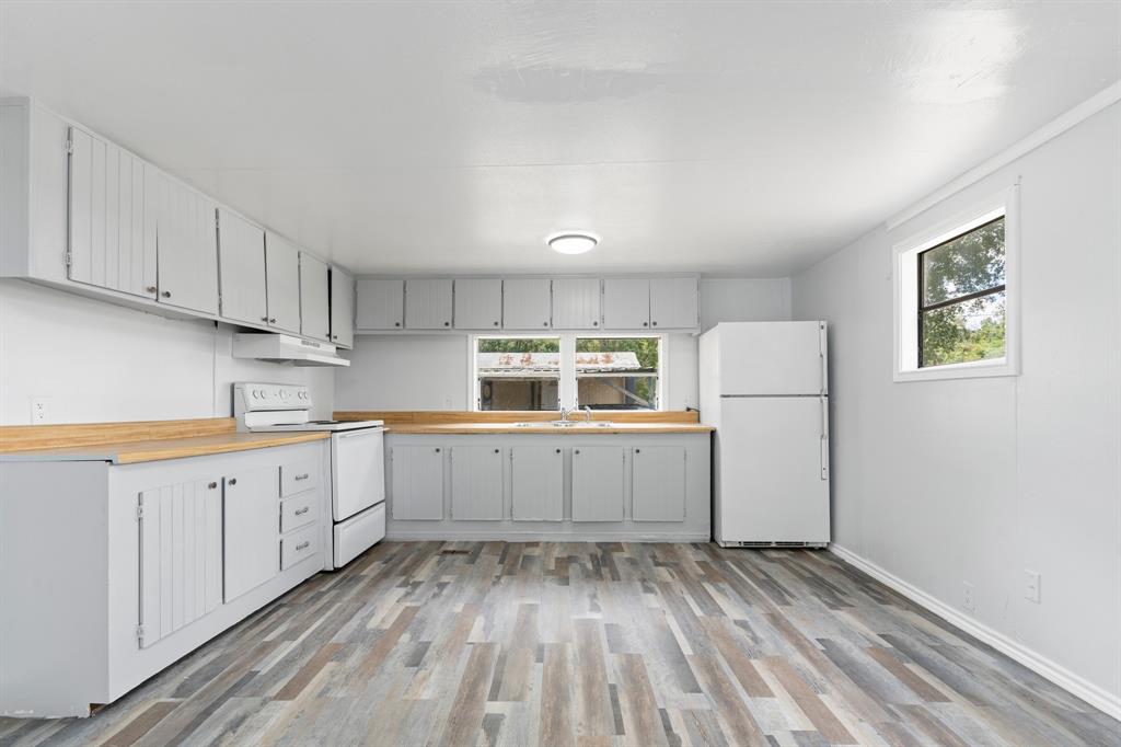 a kitchen with cabinets appliances and a window