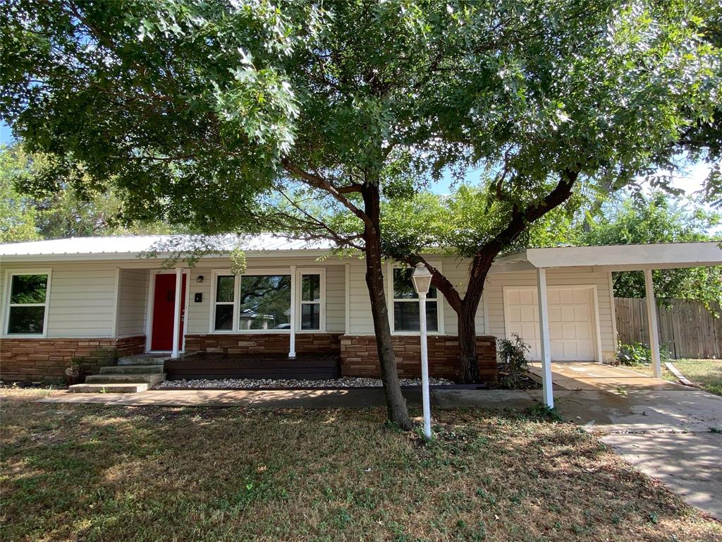 Single story home featuring a porch and a garage