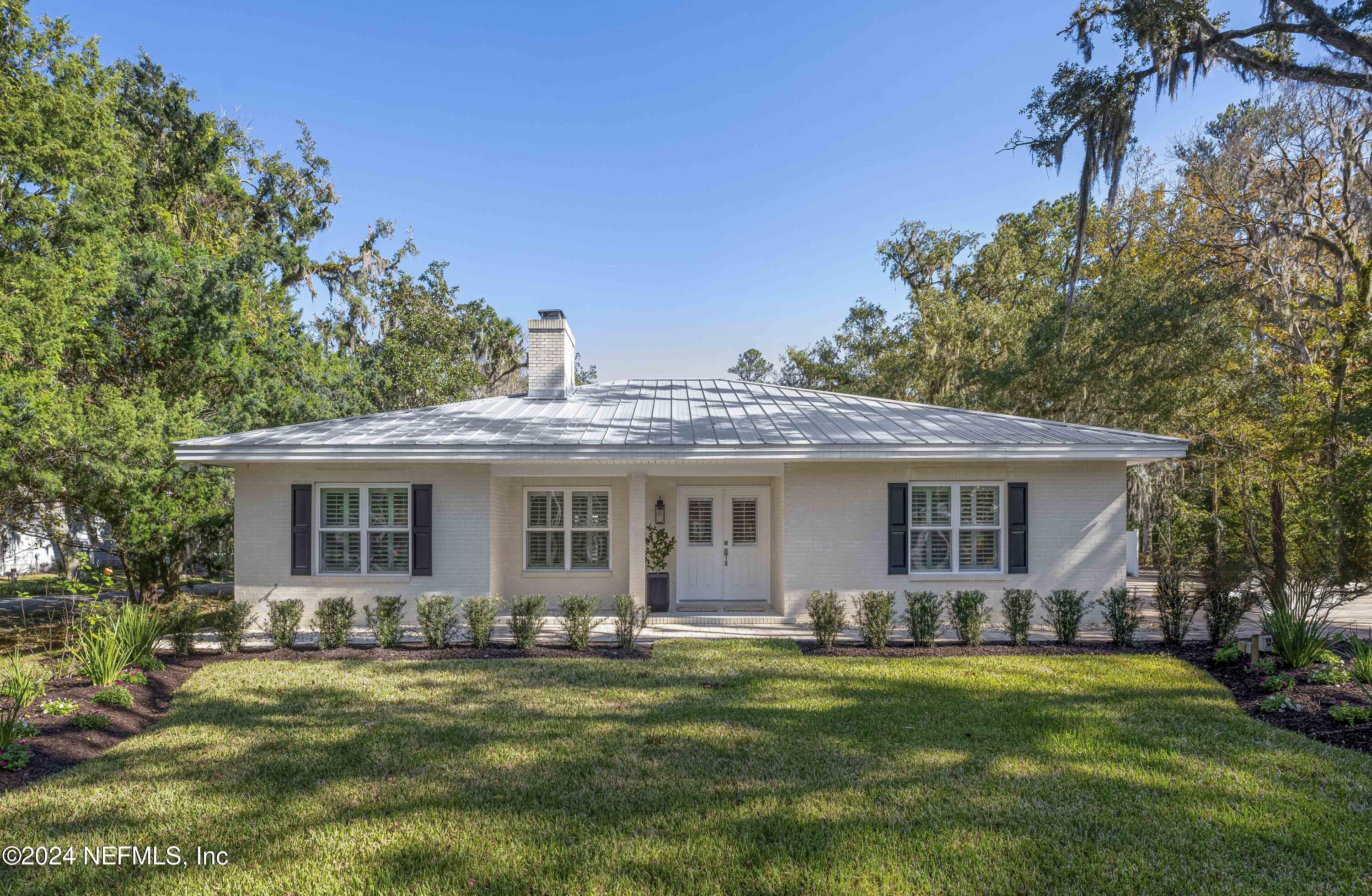 a front view of house with yard and green space