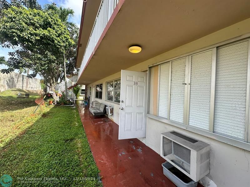 a view of a porch with furniture and garden