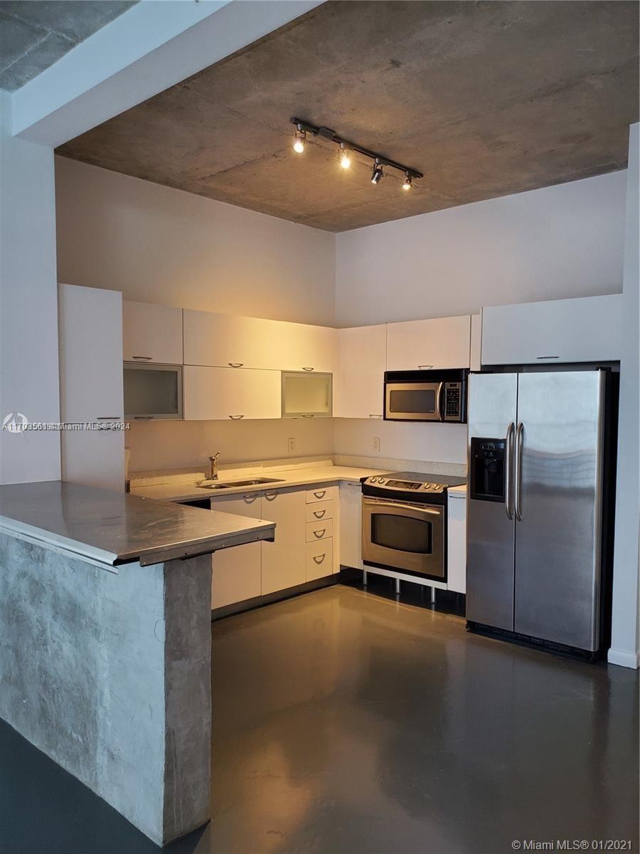 a kitchen with stainless steel appliances a stove and a refrigerator