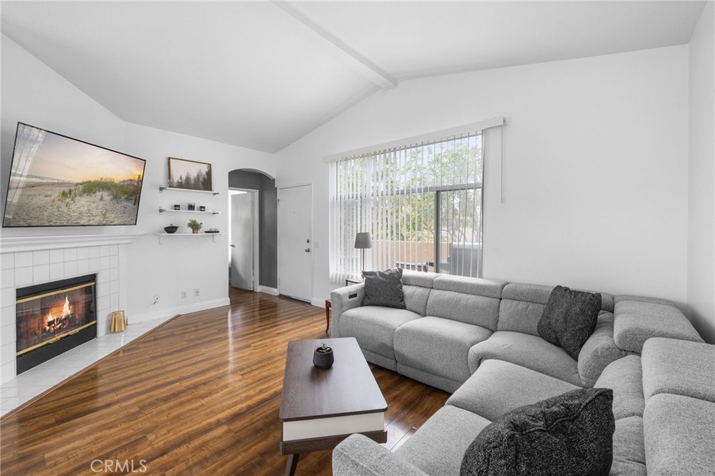 a living room with furniture wooden floor and a fireplace