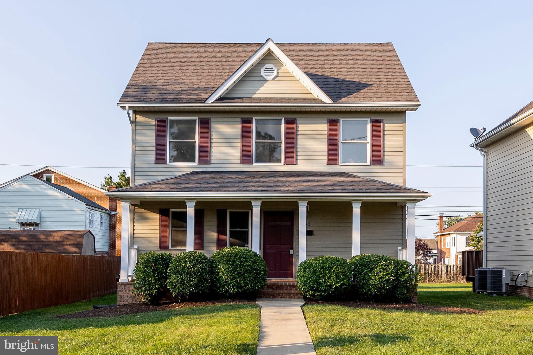 a front view of a house with yard and porch