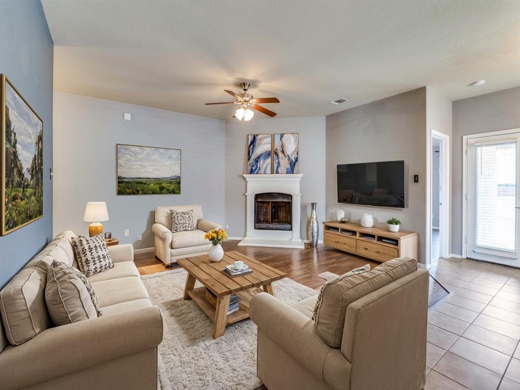 a living room with furniture a flat screen tv and a fireplace