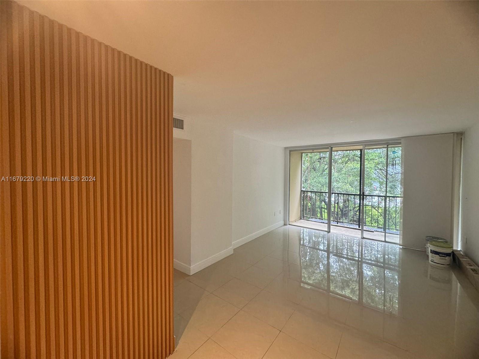 a view of an empty room with glass door